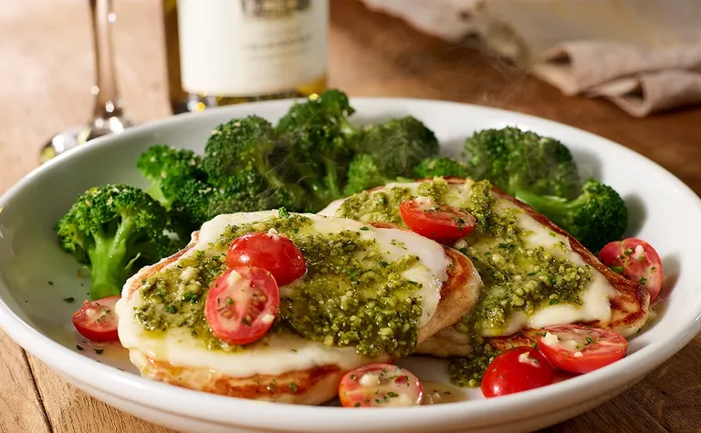 Grilled Chicken Margherita — Delight in Olive Garden's grilled chicken dish topped with tomatoes, mozzarella, basil pesto…