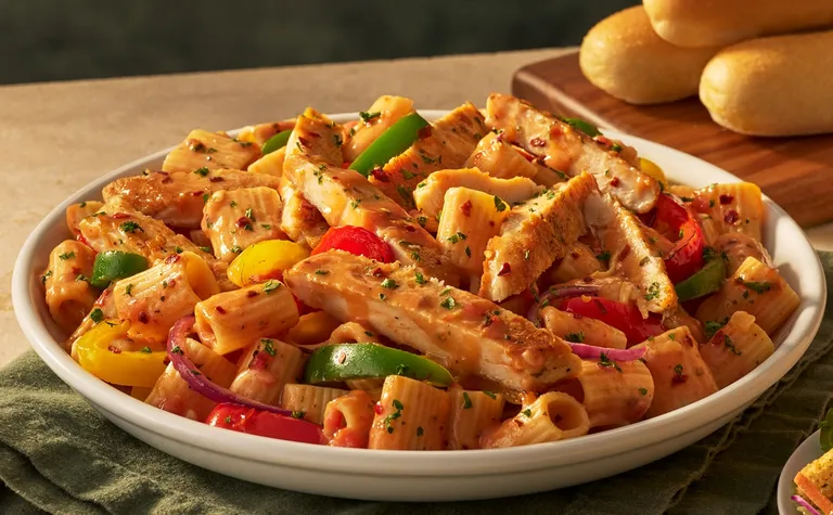 Spicy Chicken & Peppers Rigatoni — Grilled chicken, mixed bell peppers and rigatoni pasta tossed in a spicy Calabrian cream…