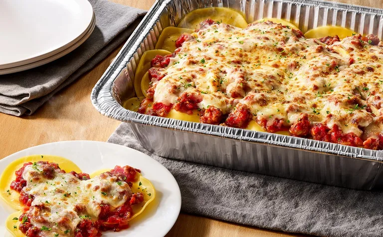 Cheese Ravioli with Marinara or Meat Sauce (Serves 4 - 6) — Includes: A pan of cheese-filled ravioli topped with marinara…