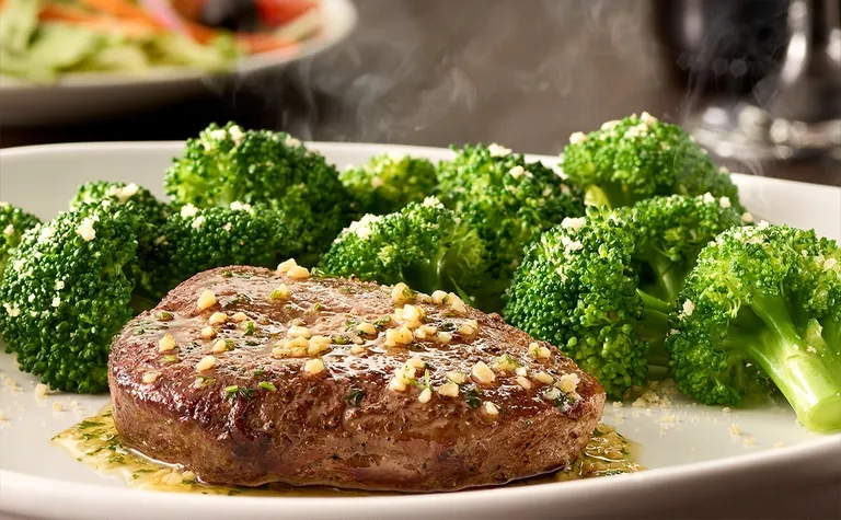 6 oz Sirloin — Grilled 6 oz sirloin* topped with garlic herb butter. Served with parmesan garlic broccoli.