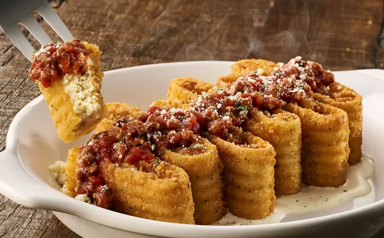 Lasagna Fritta — Fried parmesan-breaded lasagna, topped with parmesan cheese and meat sauce, with creamy alfredo.