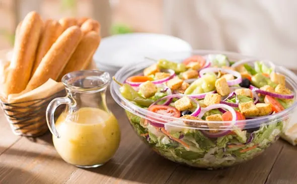 Our Famous Jumbo House Salad includes 12 Breadsticks (Serves 6) — Our famous jumbo house salad is topped with olives…