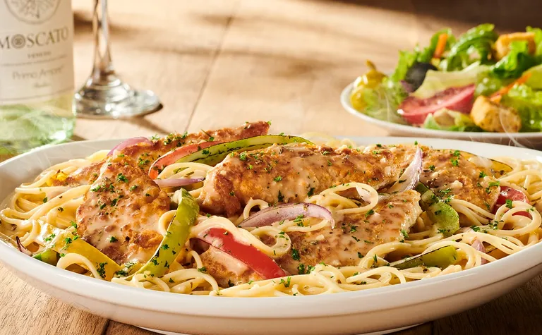 Chicken Scampi — Chicken sautéed with fresh bell peppers and red onions in a creamy scampi sauce. Served over angel hair…