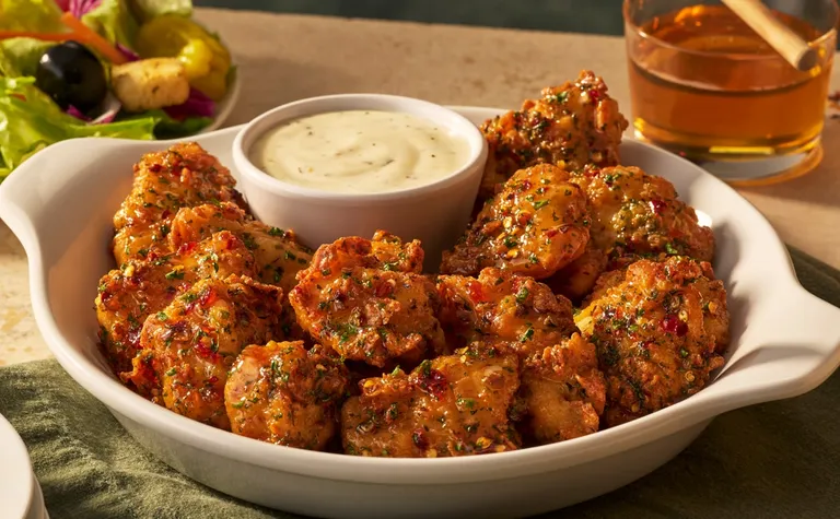 Calabrian Hot Honey Chicken Bites — Crispy chicken bites tossed in a sweet and spicy Calabrian hot honey sauce. Served with…
