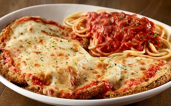 Eggplant Parmigiana — Hand-breaded eggplant, lightly fried and topped with marinara and melted mozzarella. Served with a…