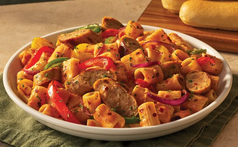 Spicy Sausage & Peppers Rigatoni — Sliced sausage, mixed bell peppers and rigatoni pasta tossed in a spicy Calabrian cream…