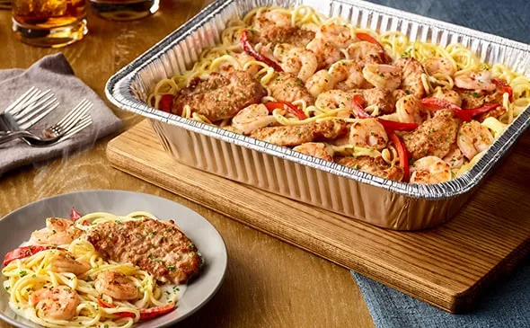 Chicken and Shrimp Carbonara (Serves 4 - 6) — Includes: A pan of sautéed seasoned chicken, shrimp and spaghetti tossed in a…