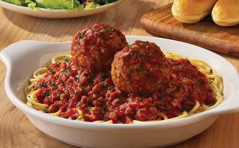Spaghetti & Meatballs — Our homemade meat sauce and two hearty meatballs (or one Italian Sausage), served over spaghetti.**