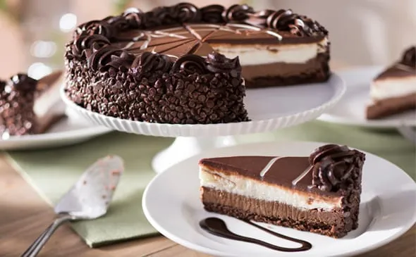 Black Tie Mousse Cake — Rich layers of chocolate cake, dark chocolate cheesecake and creamy custard mousse. Order a whole…