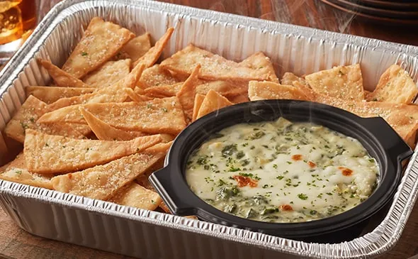 Spinach-Artichoke Dip (Serves 4 - 6) — Add the Spinach-Artichoke Dip appetizer to your next catering order. It's a blend of…