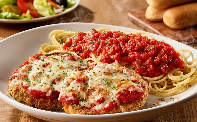 Eggplant Parmigiana — Hand-breaded, lightly fried and served with a side of spaghetti.