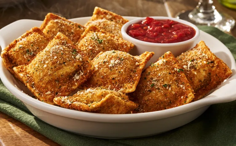 Toasted Ravioli — Lightly fried ravioli filled with seasoned beef. Served with homemade marinara sauce.