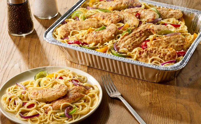 Chicken Scampi (Serves 4 - 6) — Includes: A pan of bell peppers and red onions sautéed with chicken tenderloins in a creamy…