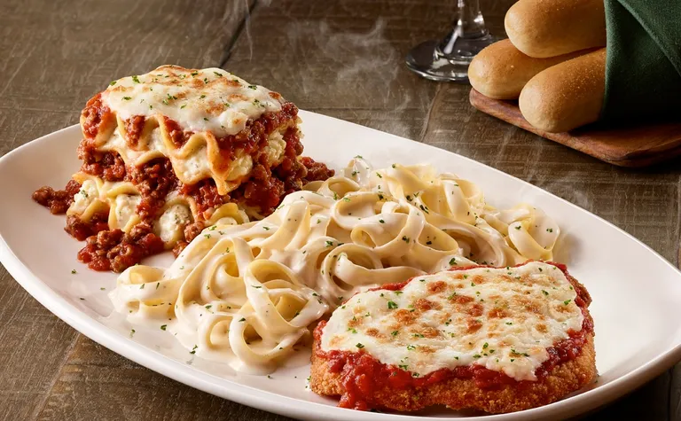 Tour of Italy — Three OG classics all on one plate! Chicken Parmigiana, Lasagna Classico and our signature Fettuccine…