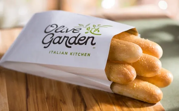 Breadsticks — Available Freshly-Baked or Bake-At-Home. Add an extra dozen or half dozen breadsticks to your online order.