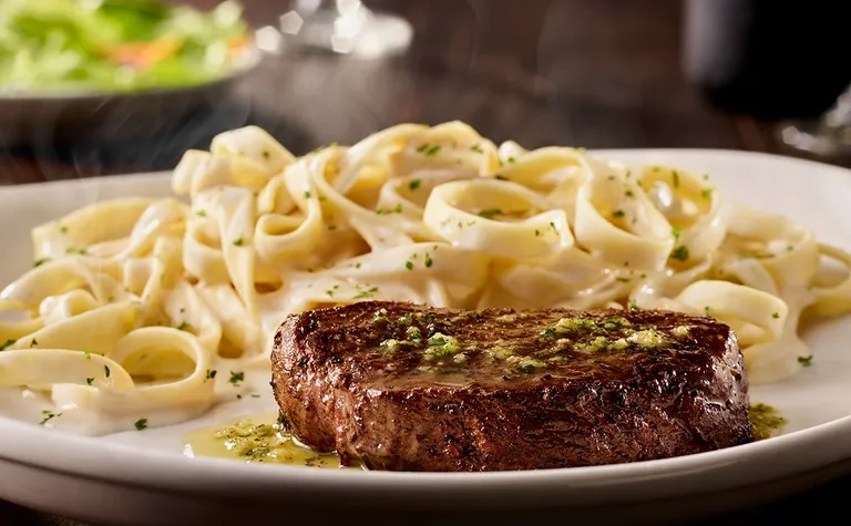 6 oz. Sirloin — Grilled 6 oz sirloin* topped with garlic herb butter. Served with a side of fettuccine alfredo.