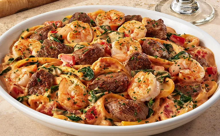 Calabrian Steak & Shrimp Bucatini* — Grilled sirloin tips*, shrimp, and bucatini pasta tossed in a spicy Calabrian cream…
