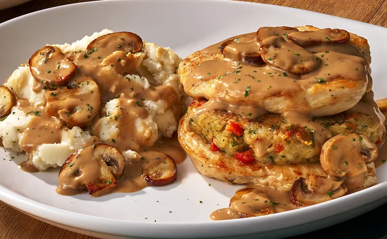 Stuffed Chicken Marsala — Grilled chicken breast stuffed with Italian cheeses and sun-dried tomatoes, topped with a creamy…