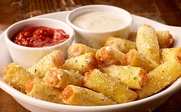 Stuffed Ziti Fritta — Start your meal with our crispy fried ziti filled with five cheeses, served with alfredo and marinara…